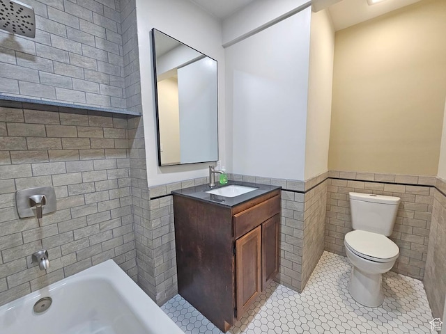 10138 S Peony Way, Sandy, UT 84094 - bathroom featuring wainscoting, tile walls, a tub, vanity, and tile patterned flooring