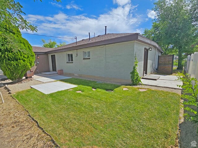 10138 S Peony Way, Sandy, UT 84094 - rear view of property with brick siding and a patio area