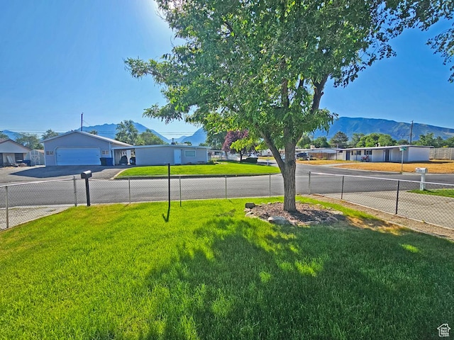 10138 S Peony Way, Sandy, UT 84094 - view of yard featuring a mountain view, a garage, and concrete driveway
