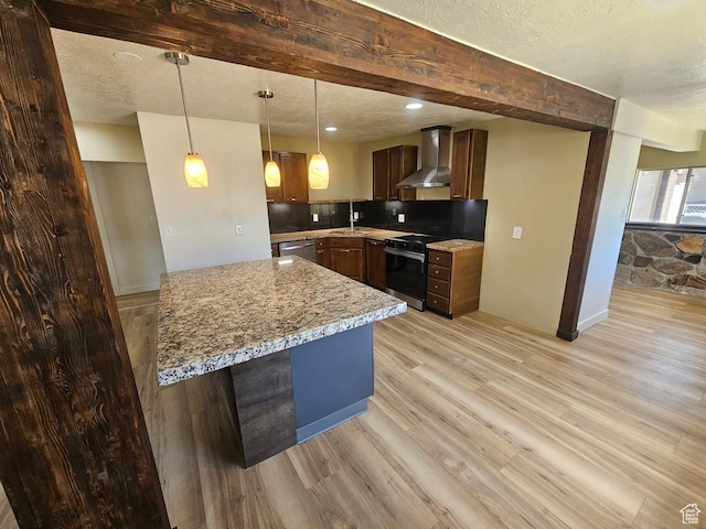 10138 S Peony Way, Sandy, UT 84094 - kitchen with wall chimney range hood, electric range oven, a textured ceiling, light wood-style floors, and decorative light fixtures
