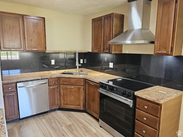 10138 S Peony Way, Sandy, UT 84094 - kitchen with wall chimney exhaust hood, dishwasher, range with electric cooktop, light wood-style flooring, and tasteful backsplash