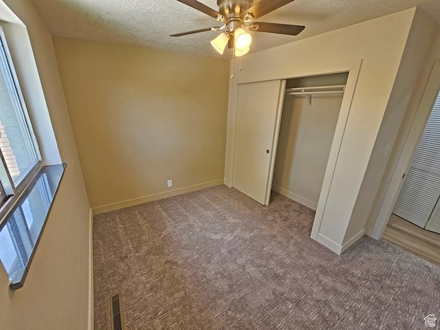 10138 S Peony Way, Sandy, UT 84094 - unfurnished bedroom featuring carpet floors, a textured ceiling, a closet, a ceiling fan, and a heating unit
