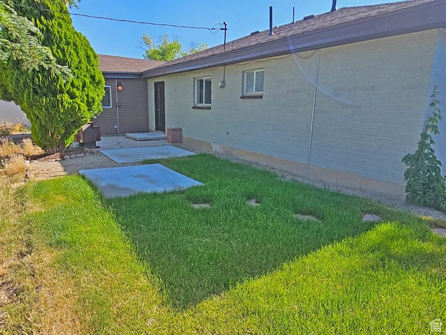 10138 S Peony Way, Sandy, UT 84094 - rear view of property featuring a yard, a patio area, and brick siding