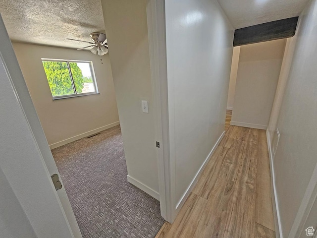 10138 S Peony Way, Sandy, UT 84094 - hall featuring a textured ceiling and wood finished floors