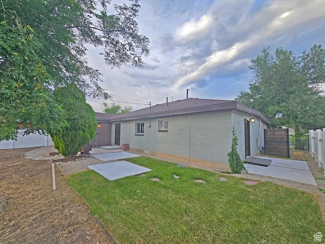 10138 S Peony Way, Sandy, UT 84094 - back of house with brick siding and a patio