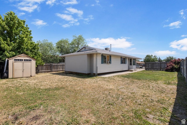 3148 S Old Glory Cir W, Magna, UT 84044 - back of house with a fenced backyard, a storage unit, and a patio area