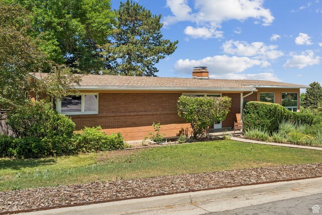 4714 S Idlewild Rd, Millcreek, UT 84124 - single story home with brick siding, a chimney, and a front yard