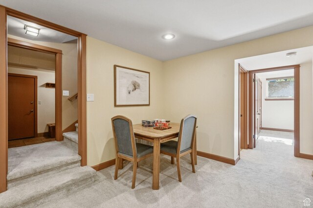 4714 S Idlewild Rd, Millcreek, UT 84124 - dining room with light colored carpet and stairway
