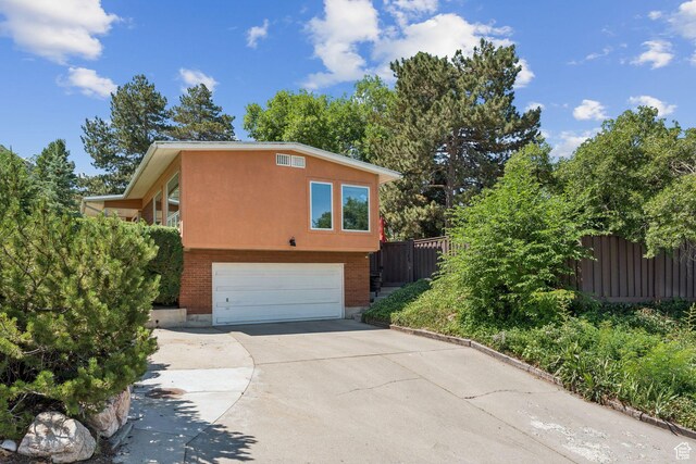 4714 S Idlewild Rd, Millcreek, UT 84124 - view of home's exterior with a garage and concrete driveway