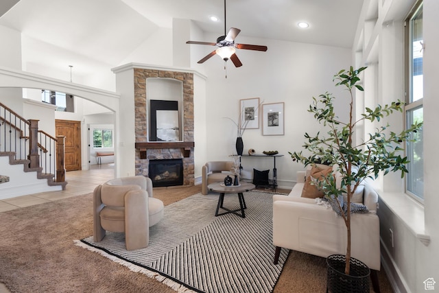 15337 S Eagle Crest Dr E, Draper, UT 84020 - living room featuring arched walkways, a ceiling fan, a fireplace, stairway, and high vaulted ceiling