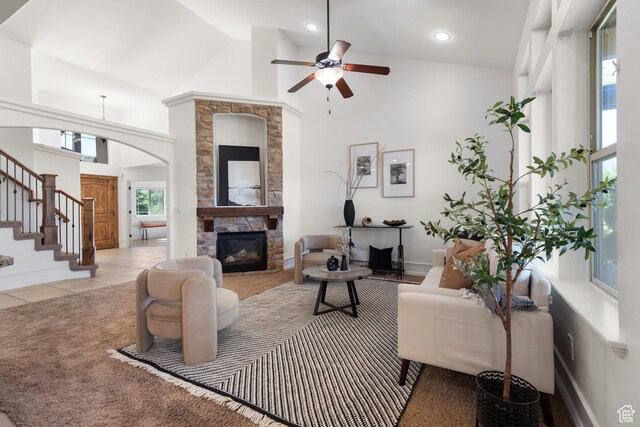 15337 S Eagle Crest Dr E, Draper, UT 84020 - living room featuring arched walkways, a ceiling fan, a fireplace, stairway, and high vaulted ceiling