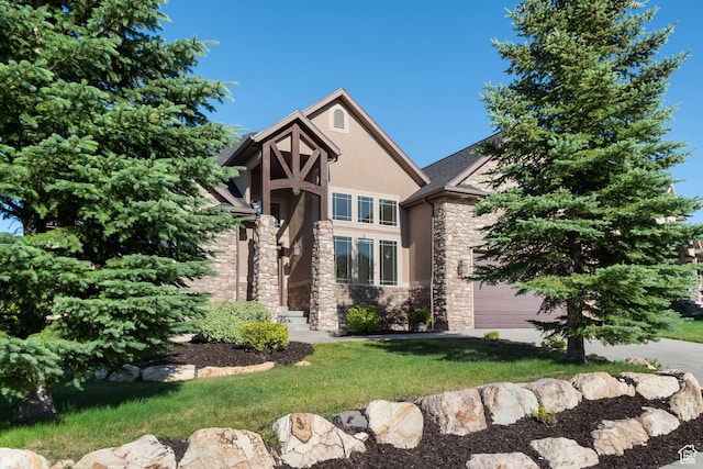 15337 S Eagle Crest Dr E, Draper, UT 84020 - tudor house with stone siding, stucco siding, a front yard, an attached garage, and driveway