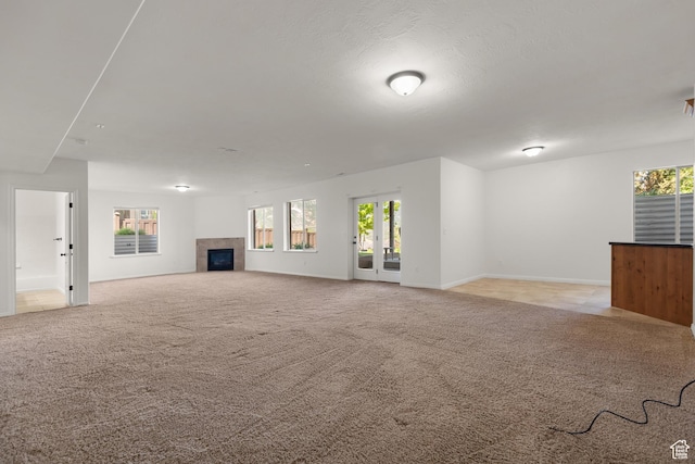 15337 S Eagle Crest Dr E, Draper, UT 84020 - unfurnished living room featuring a tiled fireplace and light colored carpet