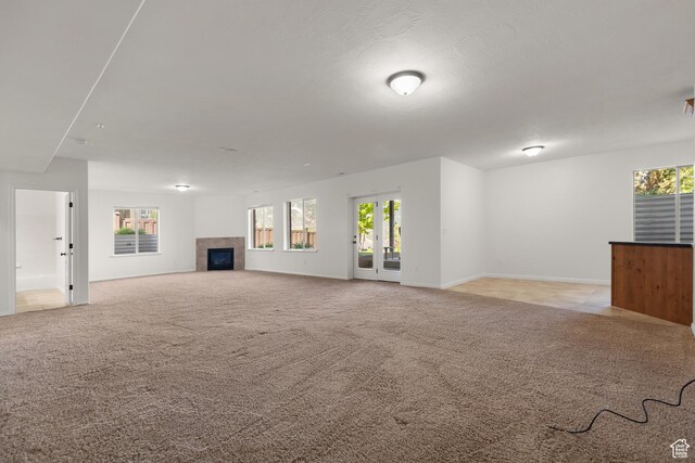 15337 S Eagle Crest Dr E, Draper, UT 84020 - unfurnished living room featuring a tiled fireplace and light colored carpet