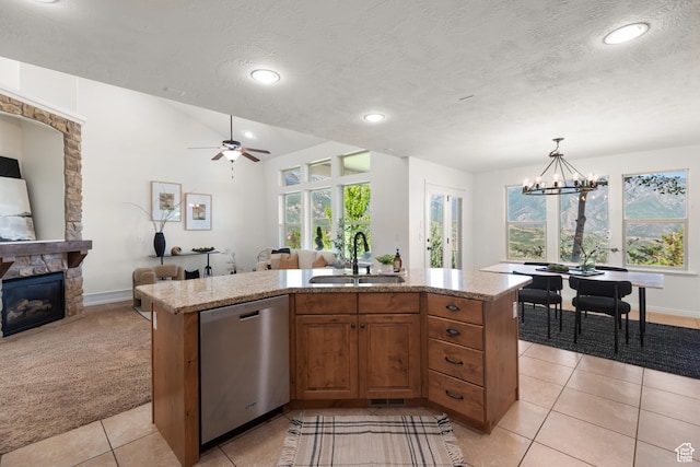15337 S Eagle Crest Dr E, Draper, UT 84020 - kitchen with dishwasher, open floor plan, a stone fireplace, light tile patterned floors, and light stone countertops