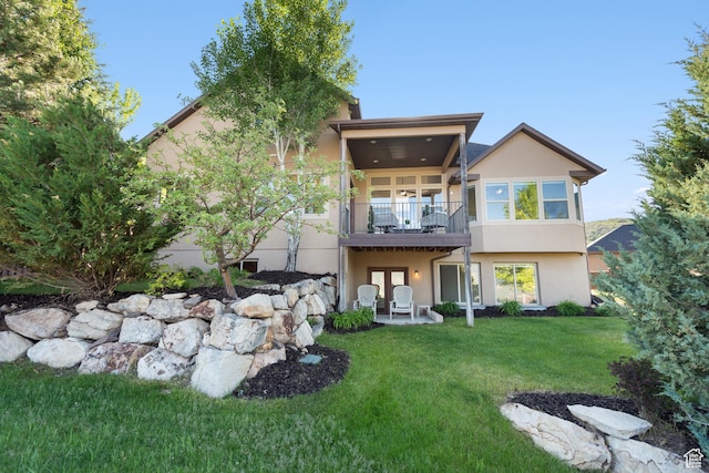 15337 S Eagle Crest Dr E, Draper, UT 84020 - rear view of house featuring stucco siding, a lawn, french doors, and a balcony