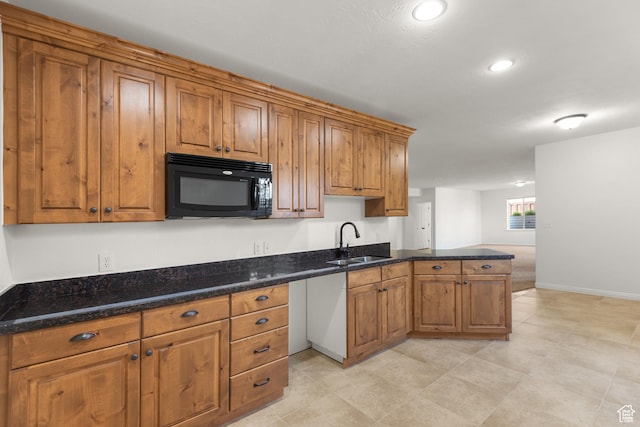 15337 S Eagle Crest Dr E, Draper, UT 84020 - kitchen with black microwave, a peninsula, brown cabinets, dark stone counters, and recessed lighting