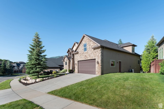 15337 S Eagle Crest Dr E, Draper, UT 84020 - view of side of home featuring stone siding, concrete driveway, stucco siding, and a garage