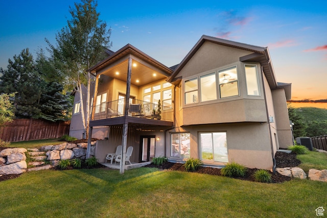 15337 S Eagle Crest Dr E, Draper, UT 84020 - back of house at dusk with a balcony and stucco siding