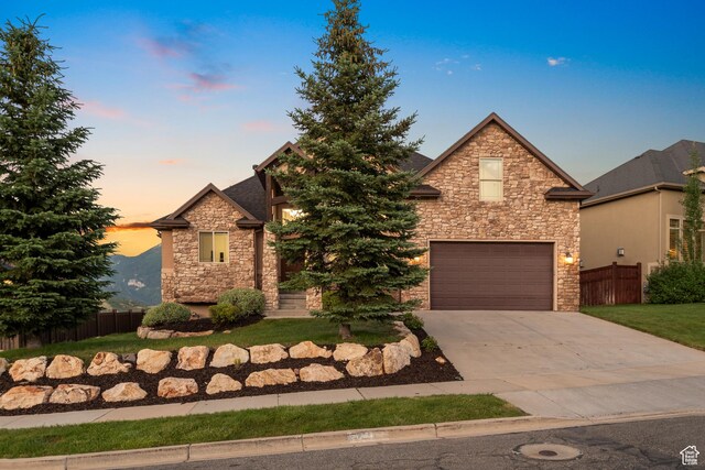 15337 S Eagle Crest Dr E, Draper, UT 84020 - view of front facade with stone siding, an attached garage, and driveway