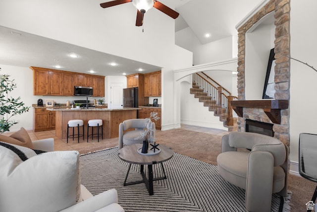 15337 S Eagle Crest Dr E, Draper, UT 84020 - living room featuring a stone fireplace, a high ceiling, recessed lighting, ceiling fan, and stairway