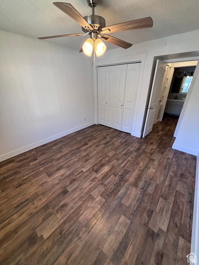 88 W 50 S Unit Q6, Centerville, UT 84014 - unfurnished bedroom with a textured ceiling, dark wood-style floors, a closet, and ceiling fan