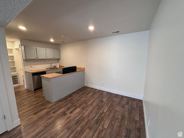 88 W 50 S Unit Q6, Centerville, UT 84014 - kitchen featuring dark wood-type flooring, a peninsula, backsplash, stainless steel dishwasher, and recessed lighting