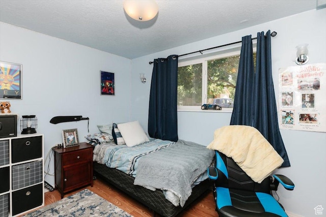 623 W 1635 N, Clinton, UT 84015 - bedroom with wood finished floors and a textured ceiling
