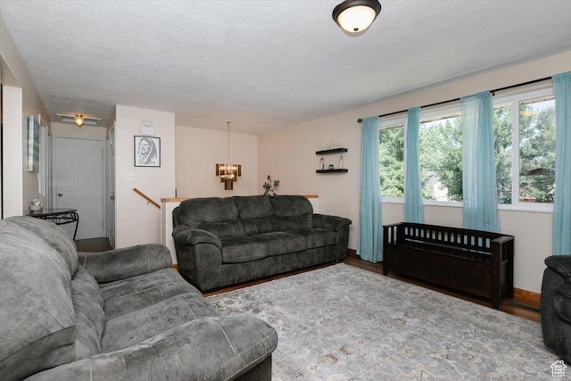 623 W 1635 N, Clinton, UT 84015 - living room with a chandelier, wood finished floors, and a textured ceiling
