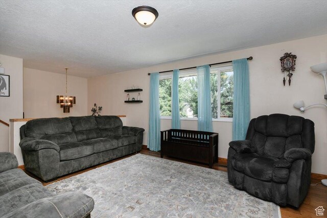 623 W 1635 N, Clinton, UT 84015 - living area featuring a chandelier, wood finished floors, and a textured ceiling