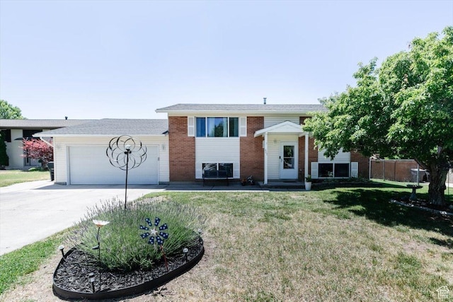 623 W 1635 N, Clinton, UT 84015 - bi-level home with driveway, an attached garage, a front lawn, and brick siding