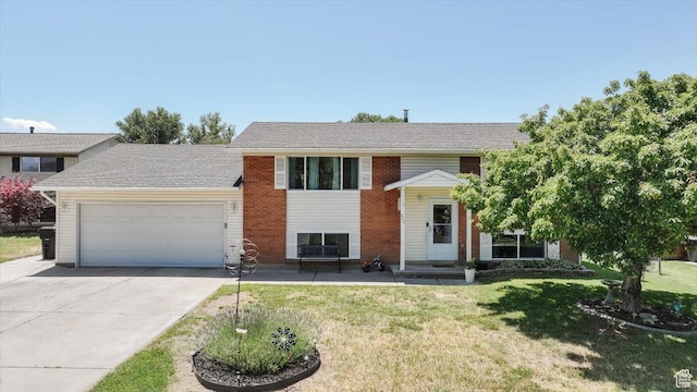 623 W 1635 N, Clinton, UT 84015 - split foyer home with a garage, concrete driveway, a front lawn, and brick siding
