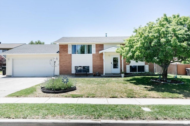 623 W 1635 N, Clinton, UT 84015 - split foyer home with a garage, a front yard, driveway, and brick siding