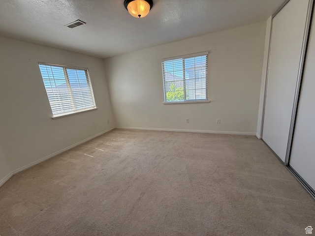 1779 W 1200 S Unit 319, Springville, UT 84663 - unfurnished bedroom with light carpet, a closet, and a textured ceiling