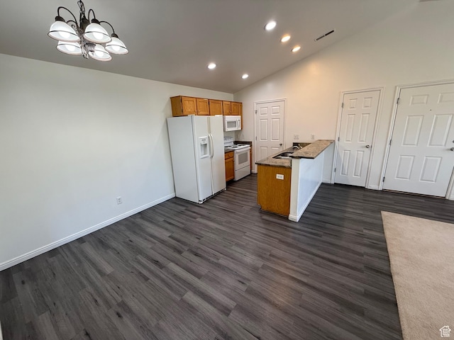 1779 W 1200 S Unit 319, Springville, UT 84663 - kitchen with white appliances, a chandelier, brown cabinetry, dark wood finished floors, and vaulted ceiling