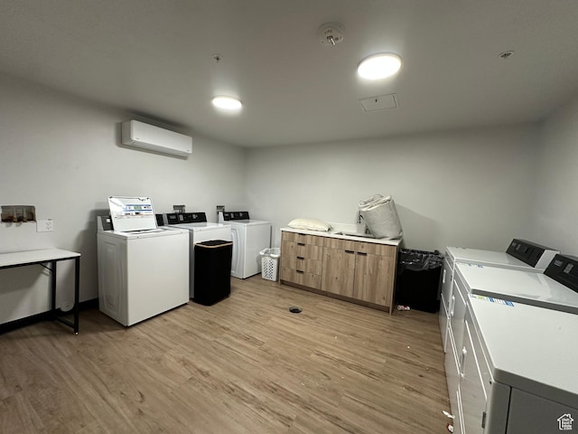 404 E 5600 S, Murray, UT 84107 - communal laundry room featuring washing machine and clothes dryer, an AC wall unit, and light wood finished floors