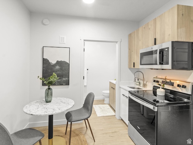 404 E 5600 S, Murray, UT 84107 - kitchen with appliances with stainless steel finishes, light brown cabinets, light wood-style flooring, and light countertops