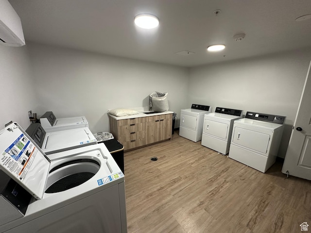 404 E 5600 S, Murray, UT 84107 - shared laundry with separate washer and dryer, light wood-style flooring, and a wall mounted AC