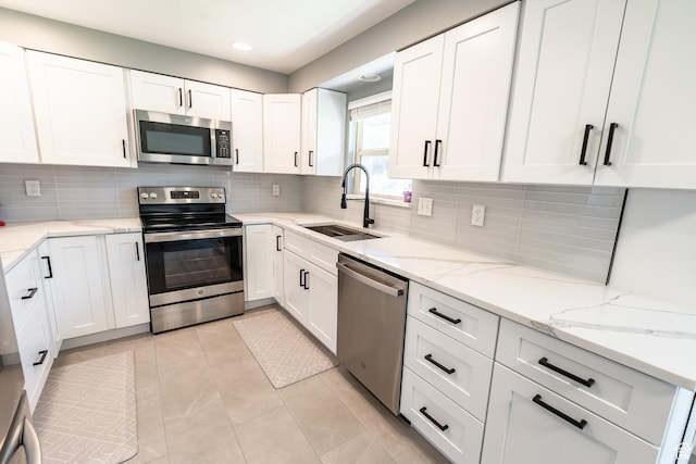 2466 N 1050 W, Clinton, UT 84015 - kitchen featuring appliances with stainless steel finishes, white cabinets, decorative backsplash, and recessed lighting