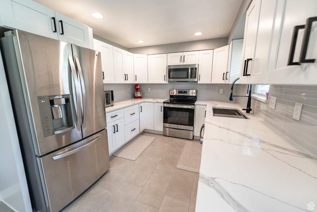 2466 N 1050 W, Clinton, UT 84015 - kitchen featuring stainless steel appliances, backsplash, white cabinetry, light stone counters, and recessed lighting