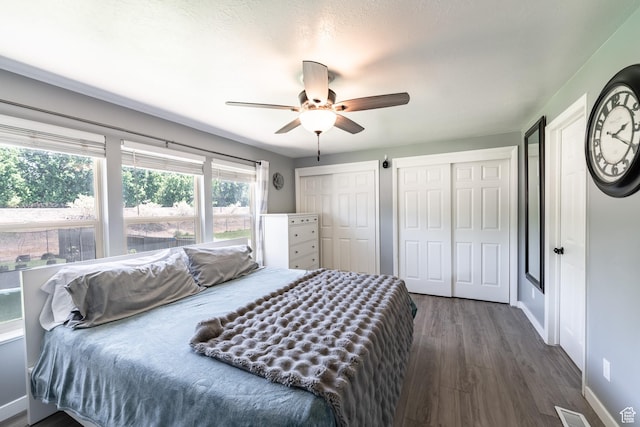 2466 N 1050 W, Clinton, UT 84015 - bedroom with two closets, dark wood-style flooring, and ceiling fan