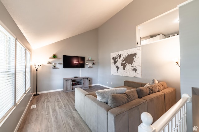 2466 N 1050 W, Clinton, UT 84015 - living area featuring lofted ceiling and light wood-type flooring