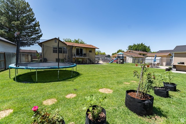 2466 N 1050 W, Clinton, UT 84015 - fenced backyard with a trampoline, a playground, and stairway