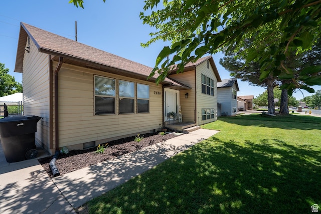 2466 N 1050 W, Clinton, UT 84015 - view of front of property featuring a front lawn and a shingled roof