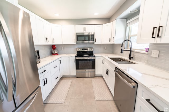 2466 N 1050 W, Clinton, UT 84015 - kitchen featuring appliances with stainless steel finishes, white cabinetry, decorative backsplash, and recessed lighting