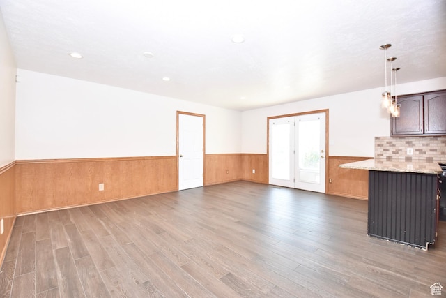 686 E 400 N, Lehi, UT 84043 - unfurnished living room featuring light wood finished floors, wainscoting, recessed lighting, and wooden walls