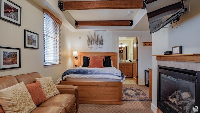 1456 W Newpark Blvd Unit 213, Park City, UT 84098 - bedroom featuring a glass covered fireplace, ensuite bathroom, beamed ceiling, and light colored carpet
