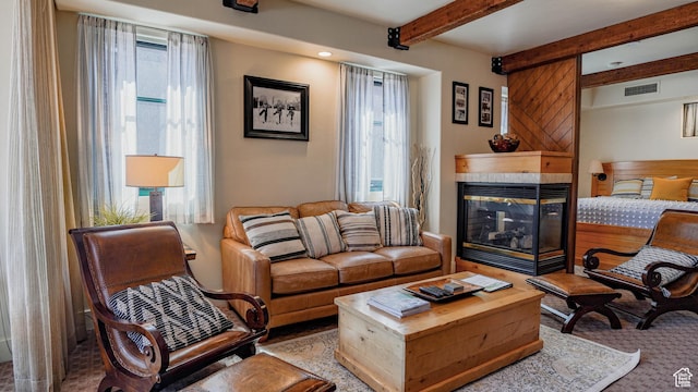1456 W Newpark Blvd Unit 213, Park City, UT 84098 - living area featuring a fireplace, beam ceiling, and carpet