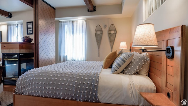 1456 W Newpark Blvd Unit 213, Park City, UT 84098 - bedroom with beamed ceiling and a fireplace