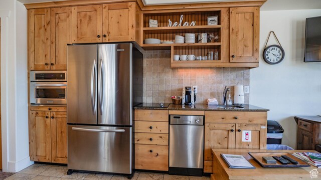 1456 W Newpark Blvd Unit 213, Park City, UT 84098 - kitchen featuring appliances with stainless steel finishes, tasteful backsplash, dark stone countertops, light tile patterned flooring, and open shelves